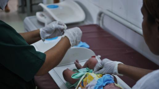 Healthworkers attend to a newborn a few minutes after birth at a community health center in Timor-Leste. 